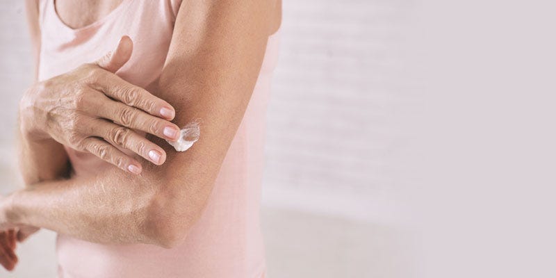 Lady applying lotion to arm